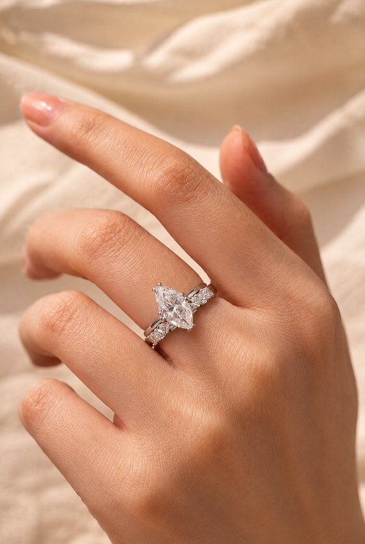 Marquise moissanite solitaire and curved accent band worn together on a hand
