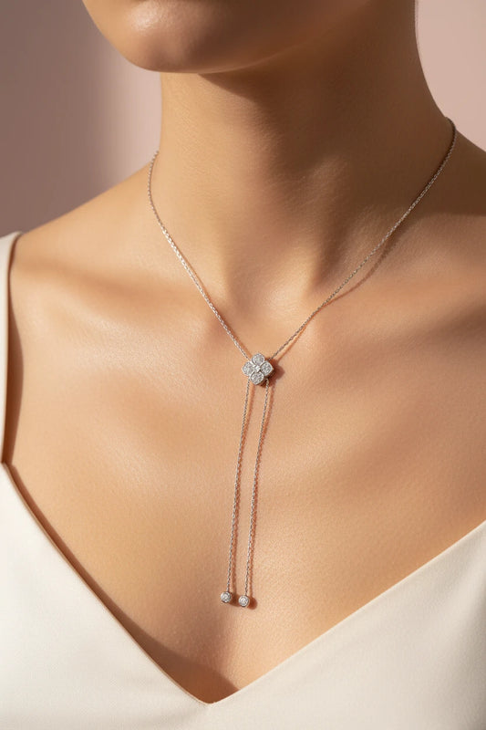 Silver floral moissanite pendant necklace by Zethech, featuring sparkling gemstone and intricate floral design.