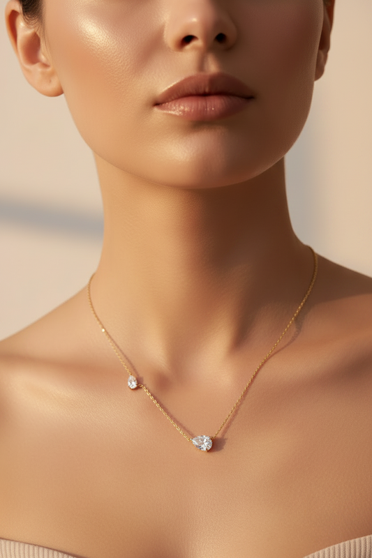 Silver twin pear-shaped moissanite necklace by Zethech with two 2.5cttw pear-cut gems on a sterling silver chain.