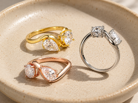 Round- and pear-cut moissanite toi et moi rings in gold, rose-gold and silver tones