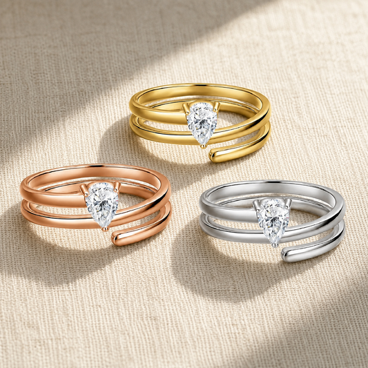Delicate pear-cut moissanite rings in yellow, rose, and silver-tone wraparound designs