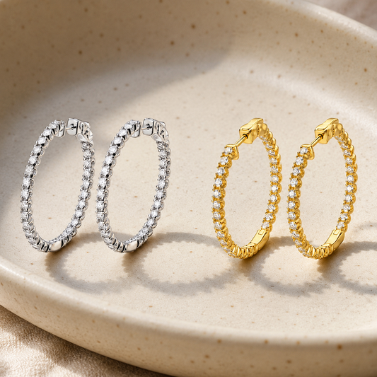Statement moissanite hoop earrings in white and yellow gold-plated finishes in a ceramic dish