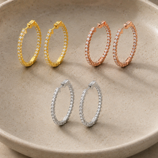 Moissanite halo hoop earrings in white, yellow and rose gold-plated finishes in a ceramic dish