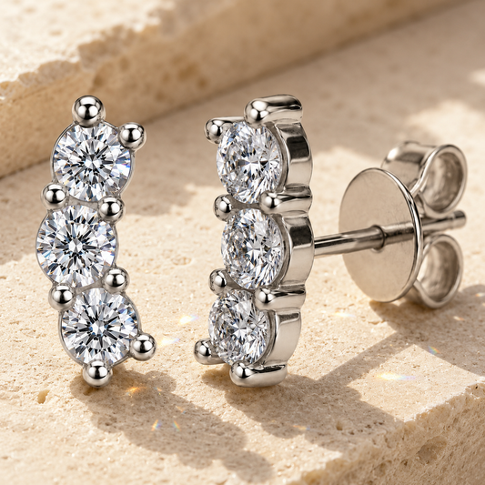 Round-cut cluster moissanite stud earrings showing three graduated stones and side profile