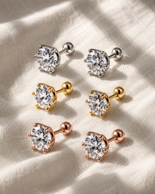 Classic round moissanite stud earrings in white, yellow and rose gold-plated finishes on fabric