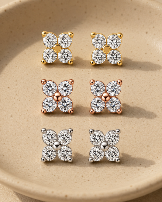 Quad moissanite stud earrings in white, yellow and rose gold-plated finishes in a ceramic dish