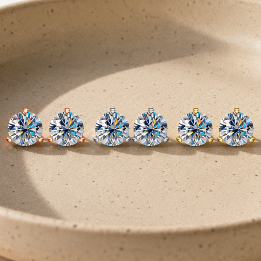 Nova round-cut moissanite stud earrings in several sizes lined across a ceramic dish