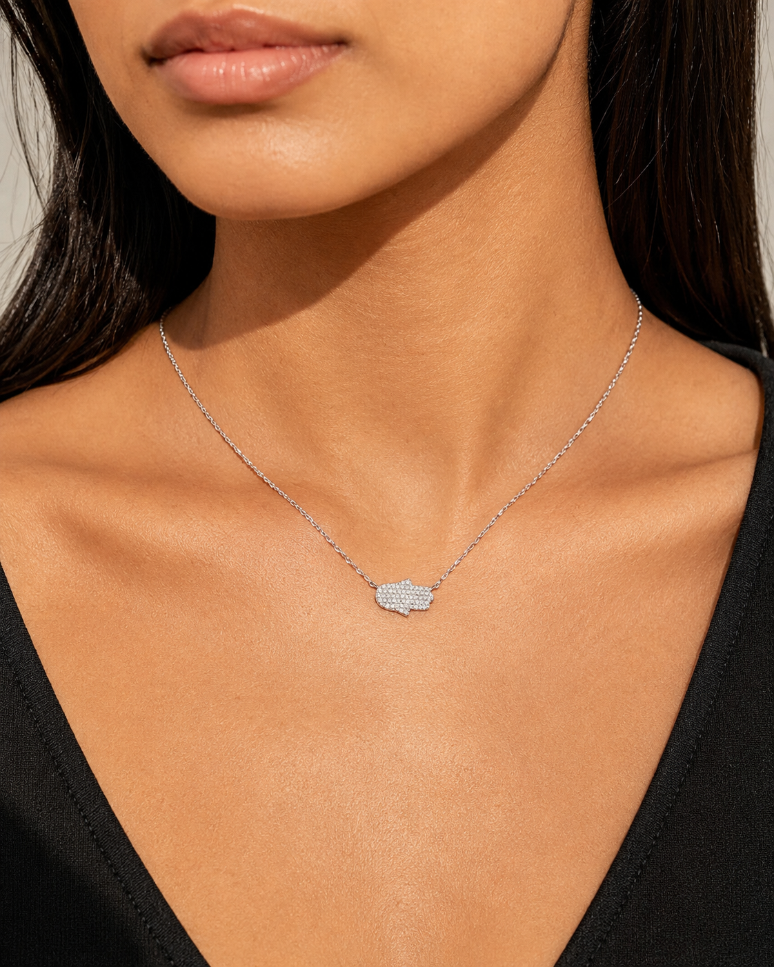Zethech Moissanite Hamsa Necklace worn by model in close-up