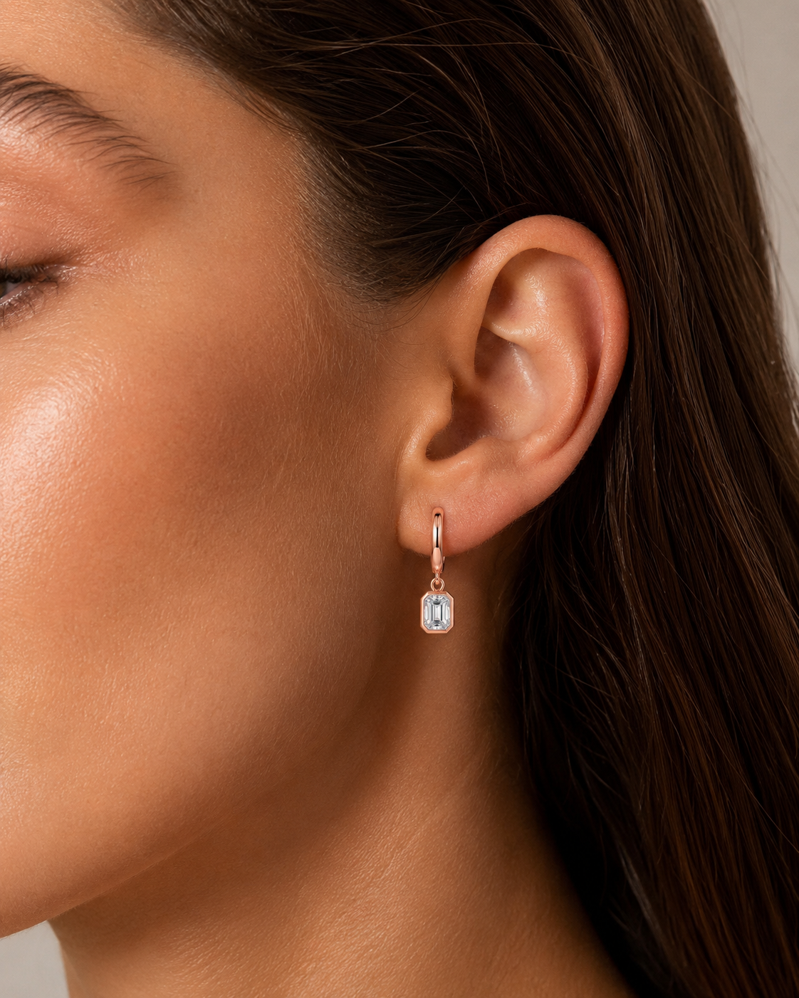 Zethech Signature Emerald Drops worn on ear in rose gold with colored stone detail