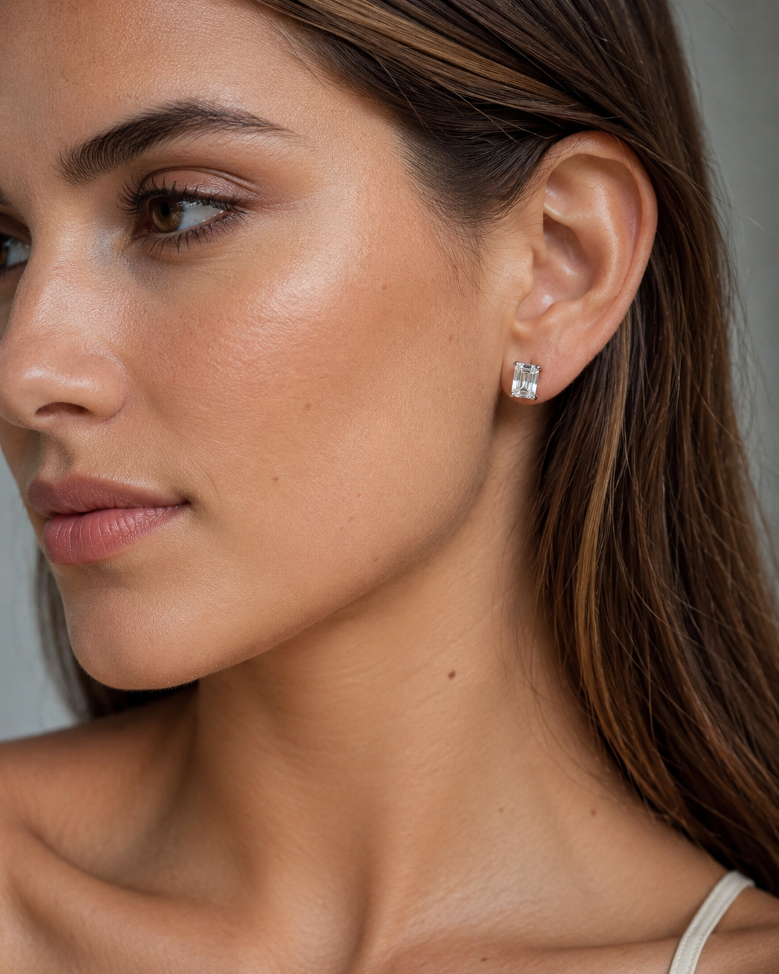 Close-up of Zethech Luna Emerald Stud Earrings on ear