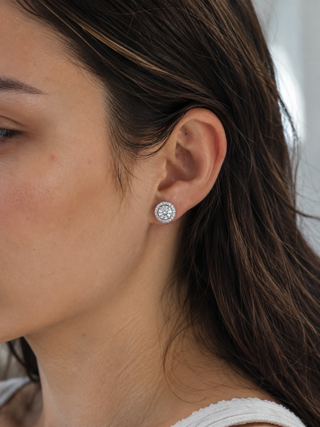Close-up of Zethech Halo Stud Earrings with round center stones