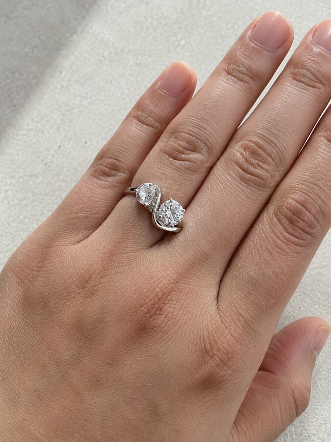 Close-up of Zethech Round Pear Ring with pear and round stones