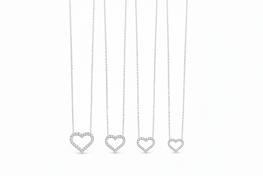 Moissanite heart pendant necklace in polished metal with a heart-shaped center stone