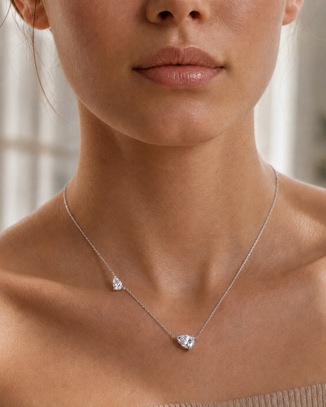 Close-up of Zethech Twin Pear Necklace with pear stone detail