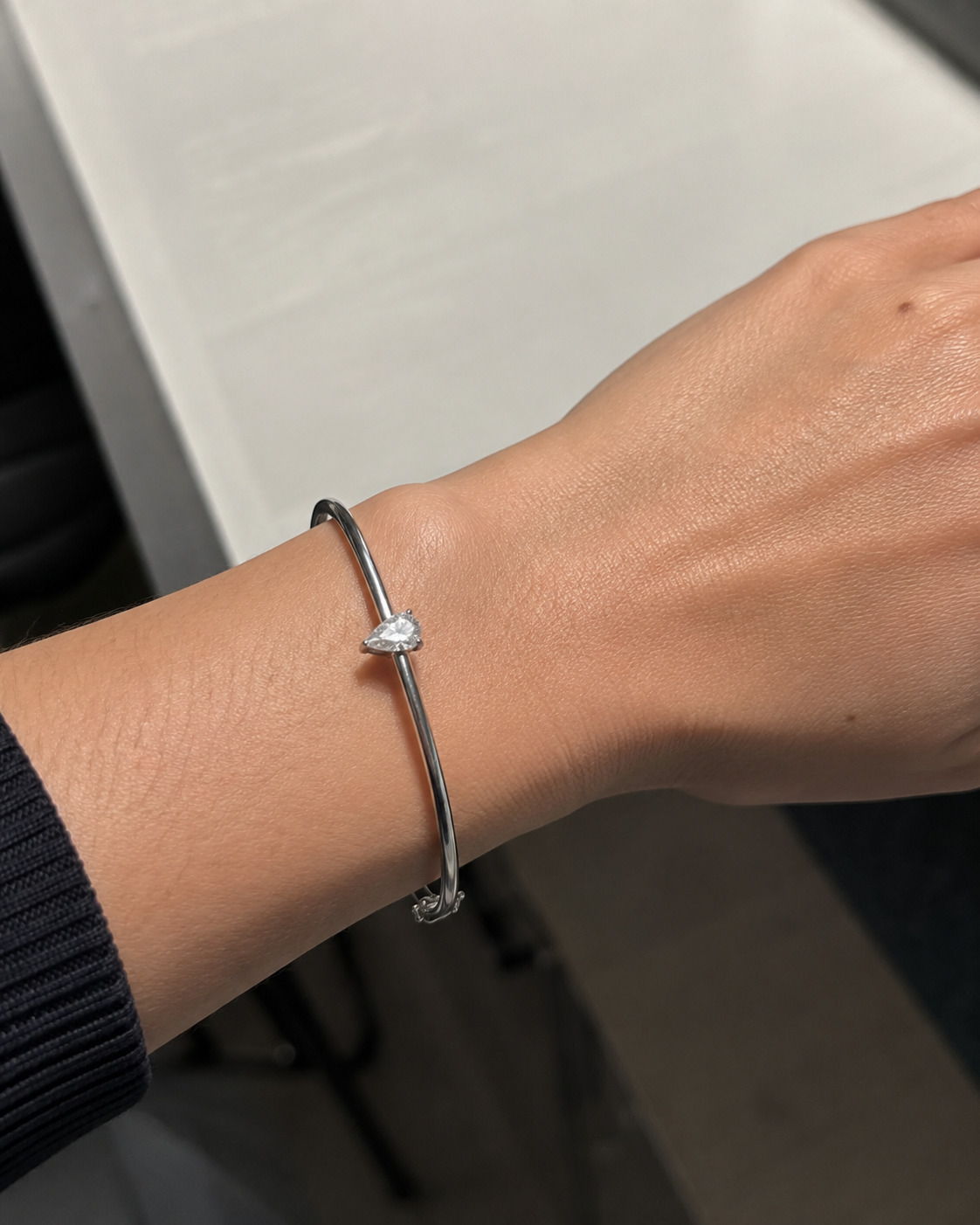 Zethech Pear Solitaire Bangle angled view with polished bangle setting