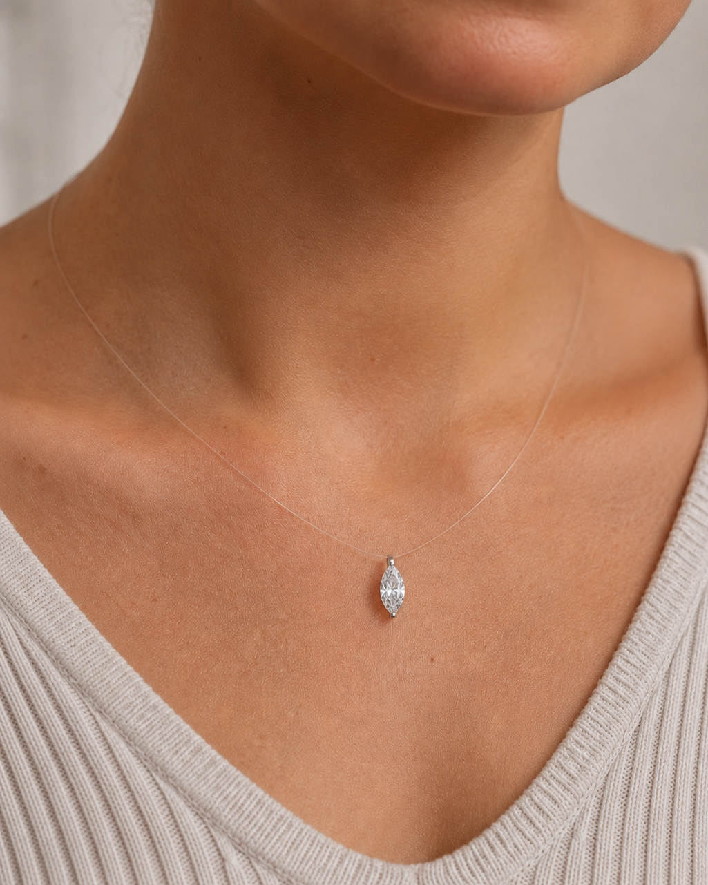 Close-up of Zethech Silhouette Necklace with oval and pear pendants