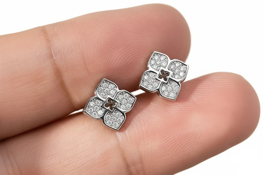 Elegant flower-shaped moissanite stud earrings by Zethech with sparkling gemstone accents and silver-tone setting.