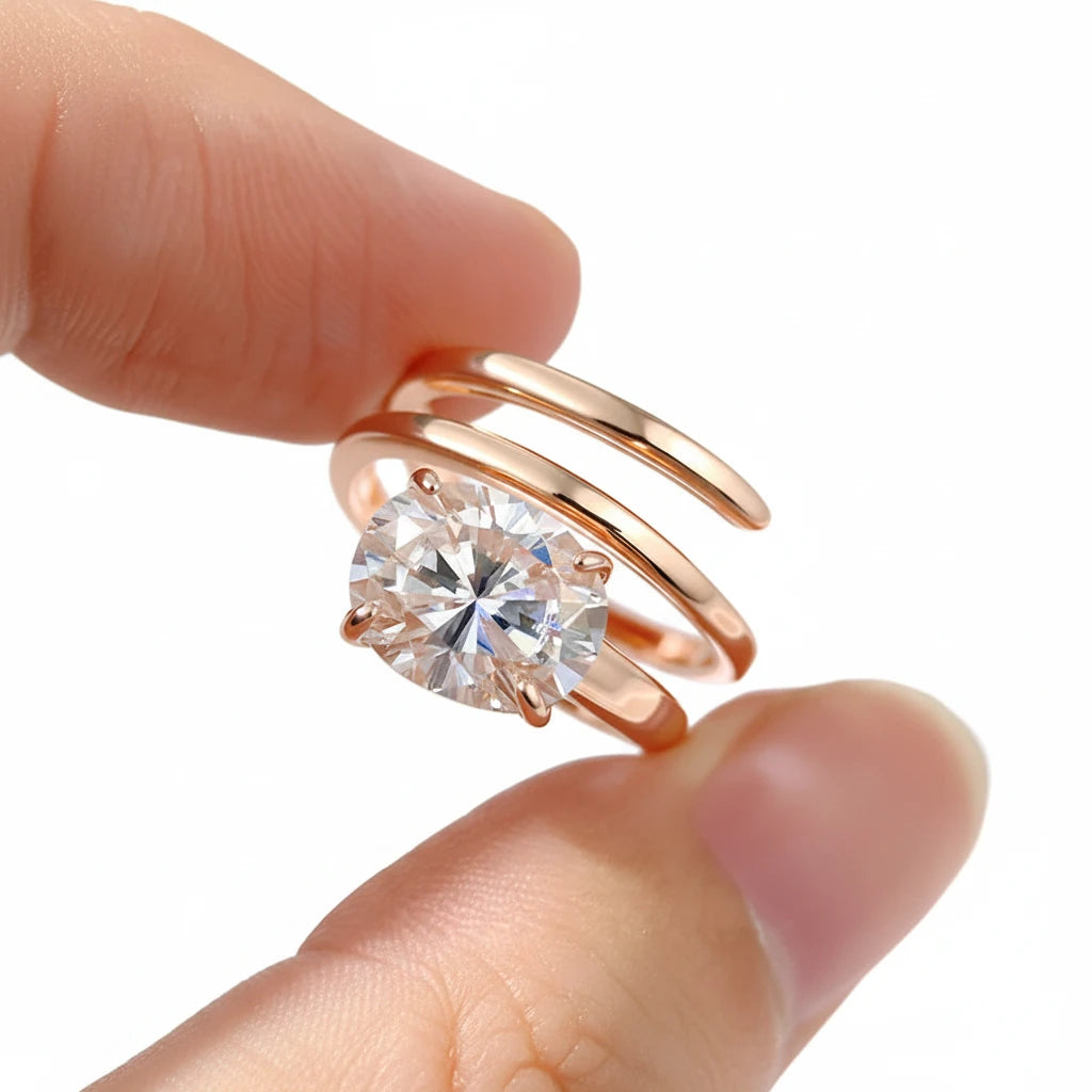 Zethech Velvet Oval Moissanite Ring in rose gold held between fingers