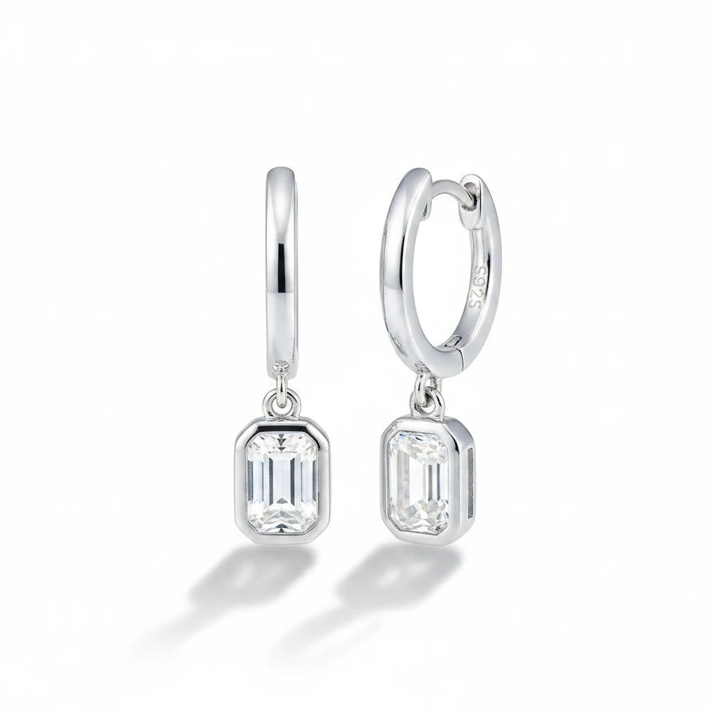 Zethech Emerald Cut Drop Earrings on reflective surface