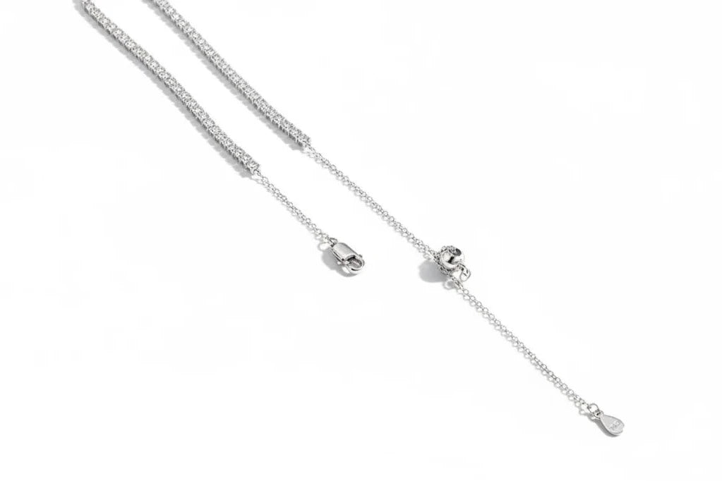 Close-up of Zethech moissanite tennis necklace featuring sparkling, round-cut stones set in a sleek silver chain.