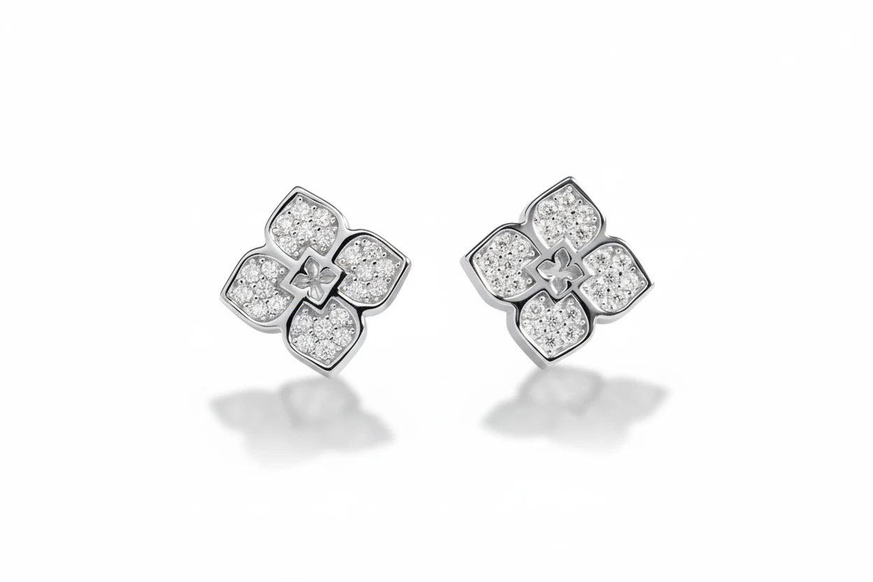 Zethech flower-shaped moissanite stud earrings with sparkling gemstones and silver posts on a white background.