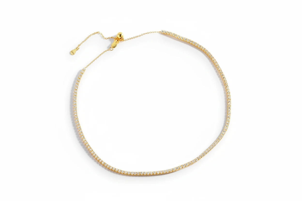 Moissanite tennis necklace by Zethech featuring sparkling gemstone-studded chain on a delicate silver setting.