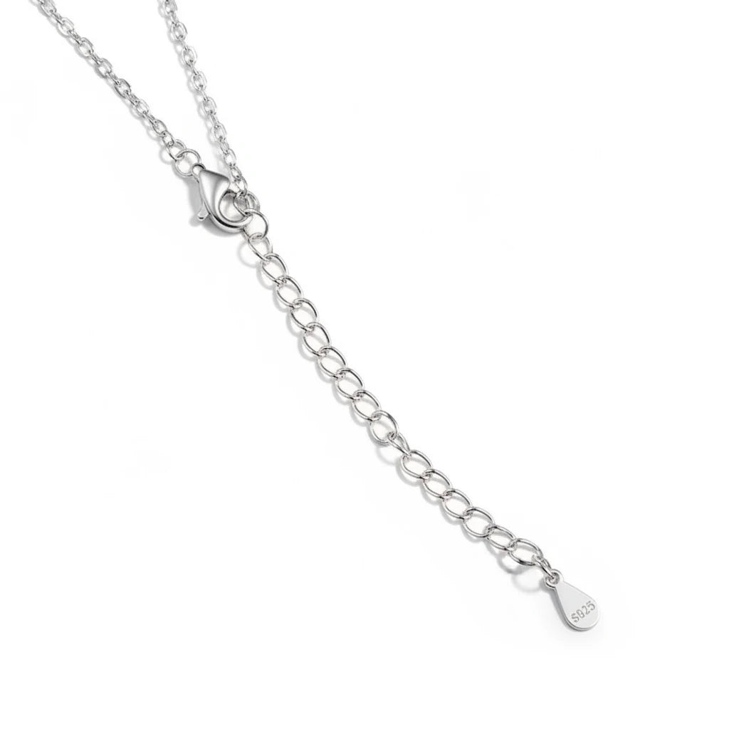 Zethech Verona Emerald Necklace chain detail on white fabric