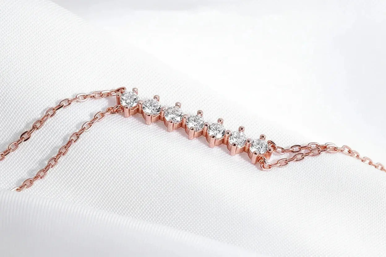 Rose gold Celestial Sparkle 7-stone adjustable moissanite bracelet for women, featuring sparkling gemstones on sterling silver chain.