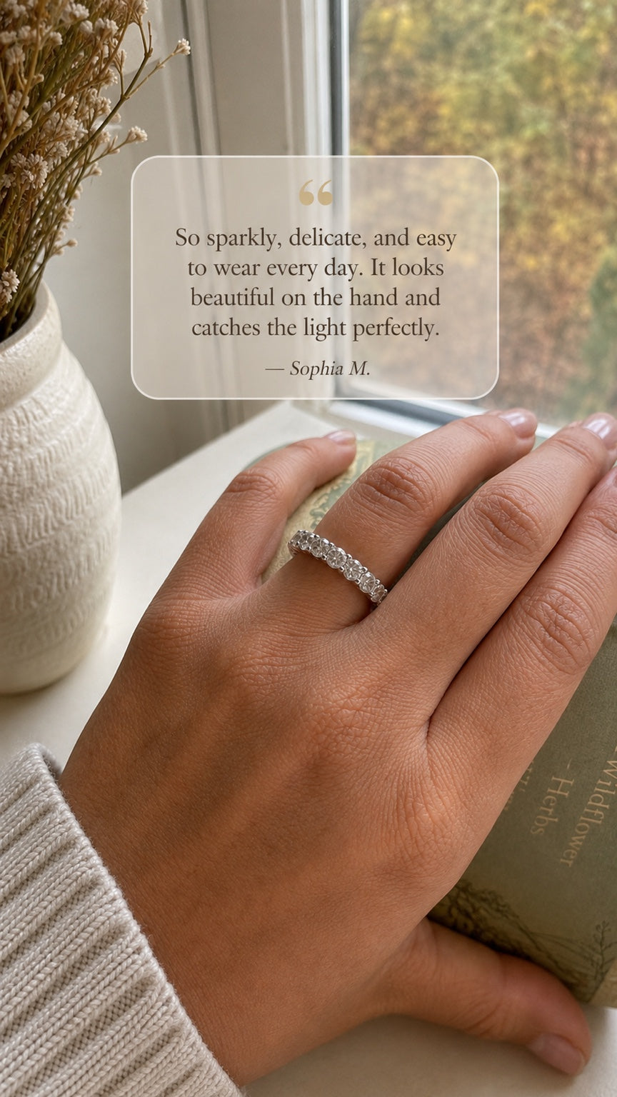 Customer wearing a moissanite eternity band. Testimonial: “So sparkly, delicate, and easy to wear every day. It looks beautiful on the hand and catches the light perfectly.” — Sophia M.
