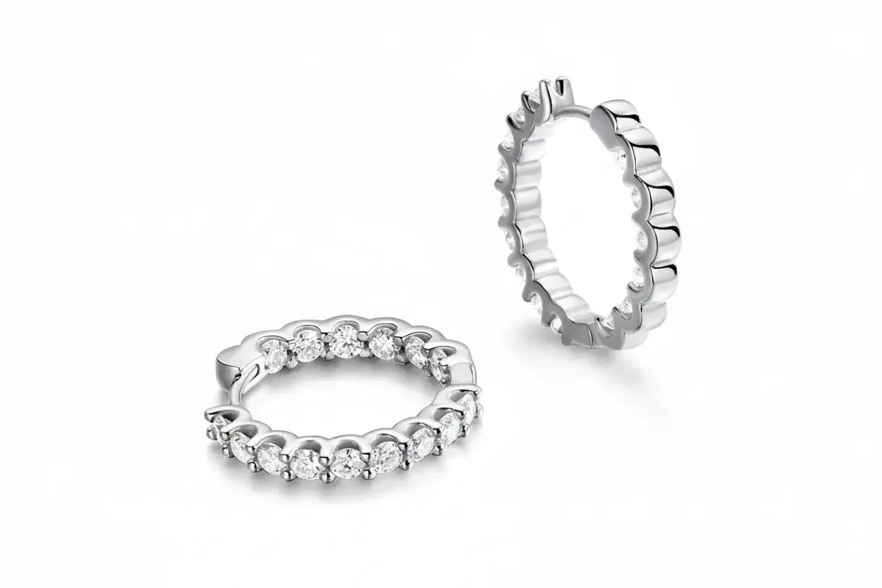 Gold-colored Zethech Eternal Glow 2.5mm full Moissanite hoop earrings, close-up view showcasing their sparkling design.