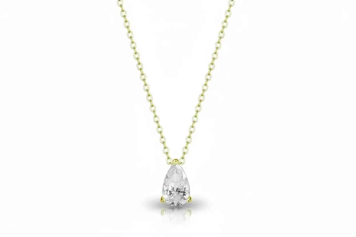 Elegant gold necklace with a 1-4 carat pear cut moissanite pendant, featuring intricate design and lab-created diamond sparkle.