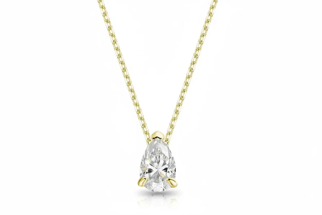 Gold pendant necklace with a 1-4 carat pear-cut moissanite by Zethech, featuring a fine silver 925 chain and elegant design.