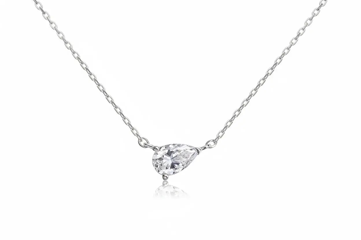Gold necklace featuring a pear-cut moissanite pendant, 1-4ct, with elegant jewelry design for women and girls.