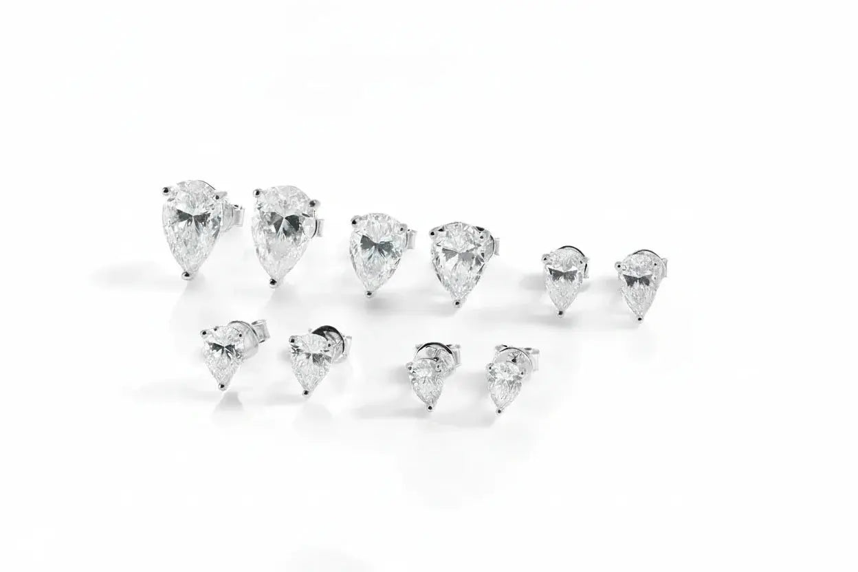 Silver-colored Zethech Radiant Teardrop Moissanite Stud Earrings with pear-cut stones, 18k gold plating, perfect for elegant jewelry.