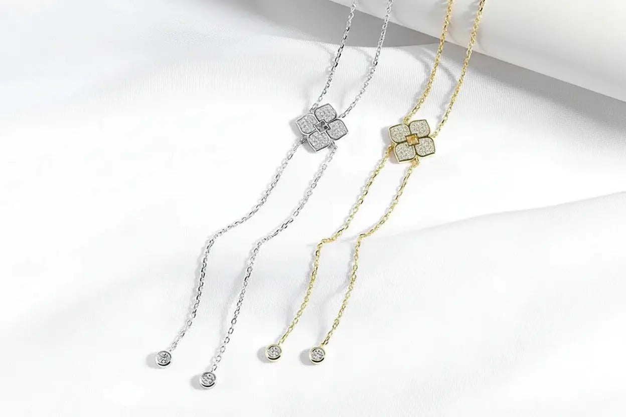 Silver floral moissanite pendant necklace by Zethech featuring sparkling gemstone accents and intricate floral design.