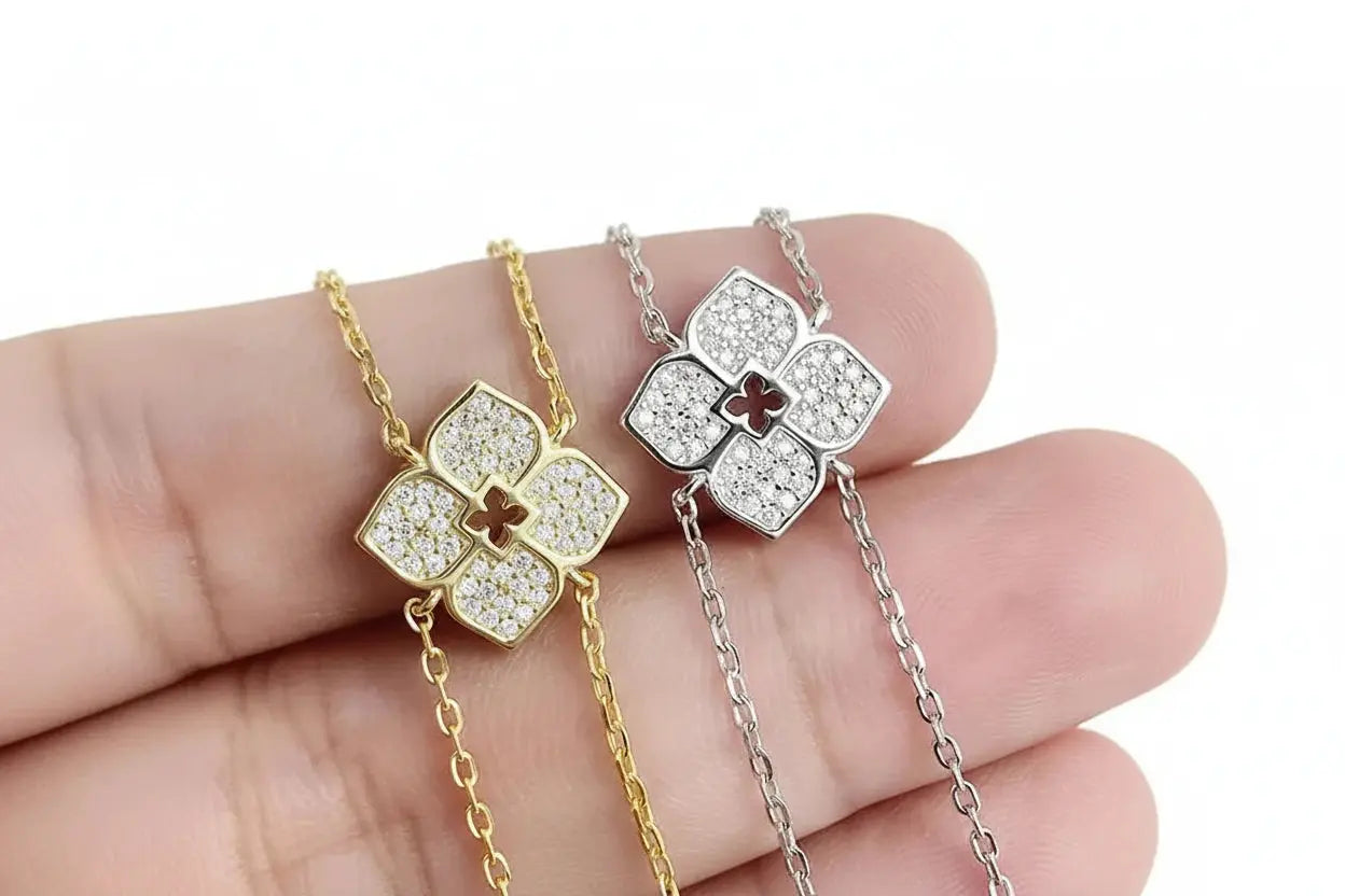 Silver floral Moissanite pendant necklace by Zethech featuring sparkling gemstone and intricate floral design.