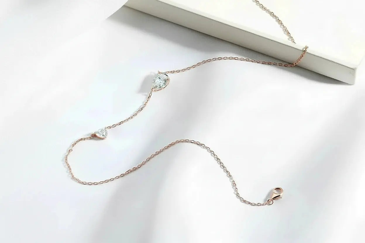 Zethech 2.5CT twin pear-shaped moissanite necklace in silver with two gemstone pendants on a sterling silver chain.