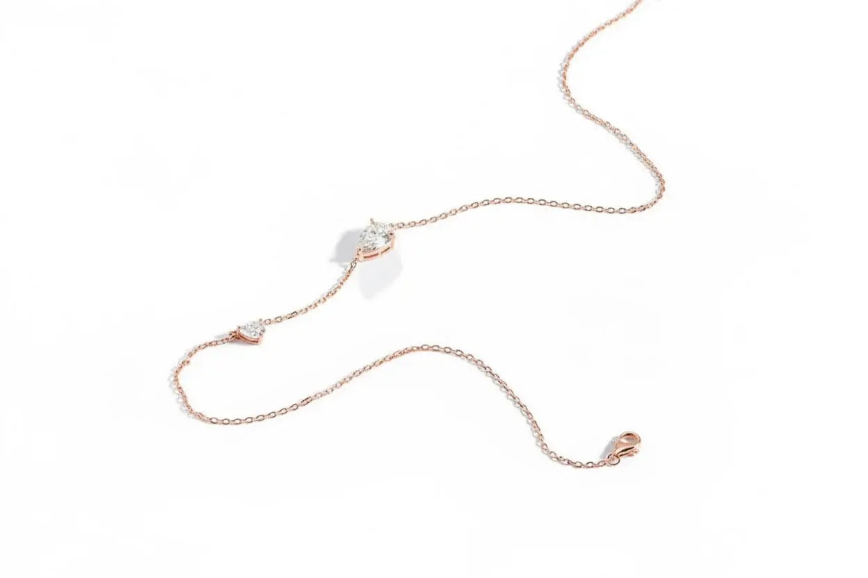 Silver Zethech 2.5CT twin pear-shaped moissanite necklace with two gemstone pendants on a sterling silver chain.