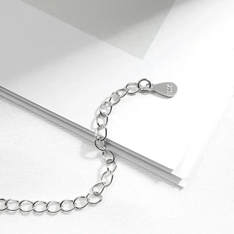 Silver Zethech 2.5CT Twin Pear Moissanite necklace with two pear-shaped lab diamond pendants on a 925 sterling silver chain.