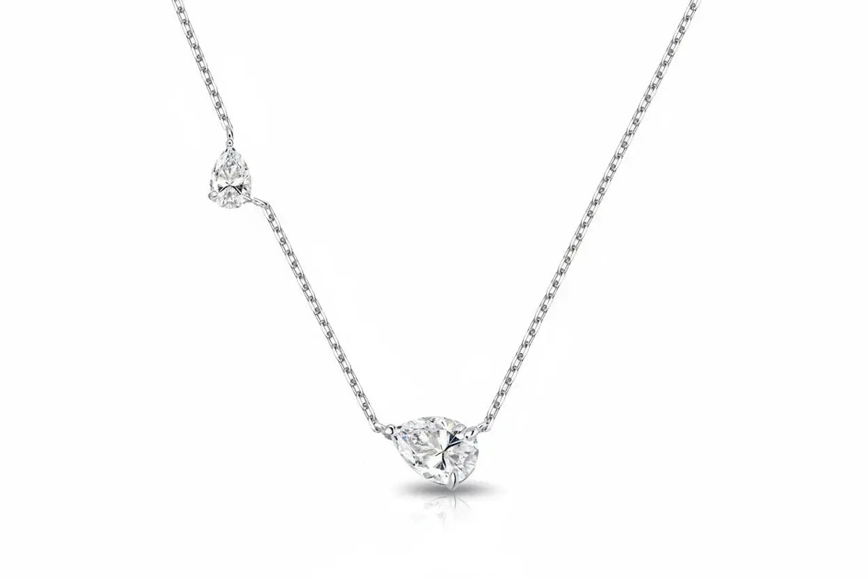 Zethech 2.5CT twin pear-shaped Moissanite necklace with silver chain, featuring two sparkling pear-cut gemstones and lab-created diamonds.